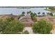 Aerial view of home with backyard landscaping, lake view, and solar panels at 11603 Heron Watch Pl, Riverview, FL 33569