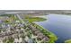 The aerial showcases the community's waterfront homes with manicured lawns, serene lake views, and lush landscaping at 11603 Heron Watch Pl, Riverview, FL 33569