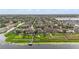 Aerial view showing waterfront homes, swimming pools, and lush green lawns along a tranquil lake at 11603 Heron Watch Pl, Riverview, FL 33569