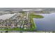 Aerial view of a community bordering a lake with meticulously maintained landscaping and roads at 11603 Heron Watch Pl, Riverview, FL 33569