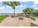 Backyard fire pit area with decorative landscaping and lake view at 11603 Heron Watch Pl, Riverview, FL 33569