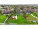 An aerial view of a landscaped backyard featuring a pool, screened-in patio, fountain, and tropical plants at 11603 Heron Watch Pl, Riverview, FL 33569