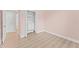 Bright bedroom with wood floor features a closet with drawers and shelves for extra storage at 11603 Heron Watch Pl, Riverview, FL 33569