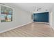 Bright bedroom with neutral walls, laminate flooring, and large window with blinds at 11603 Heron Watch Pl, Riverview, FL 33569