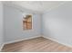 Neutral bedroom offers laminate flooring and window with shade allowing natural light at 11603 Heron Watch Pl, Riverview, FL 33569