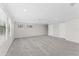 Expansive bonus room with neutral carpet, three windows and access to two doors at 11603 Heron Watch Pl, Riverview, FL 33569