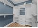 Walk-in closet features custom shelving and drawers for optimal organization at 11603 Heron Watch Pl, Riverview, FL 33569