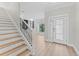 Bright foyer featuring decorative glass door and staircase with iron railing at 11603 Heron Watch Pl, Riverview, FL 33569
