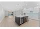 Spacious kitchen featuring an island with quartz countertops, modern appliances, and lake view at 11603 Heron Watch Pl, Riverview, FL 33569