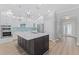 Kitchen featuring modern appliances, a large island with quartz countertops and custom cabinets at 11603 Heron Watch Pl, Riverview, FL 33569