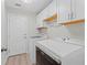 Functional laundry room with white cabinetry, countertops, and modern washer and dryer at 11603 Heron Watch Pl, Riverview, FL 33569