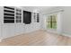 Living room featuring custom built-in shelves and a large window at 11603 Heron Watch Pl, Riverview, FL 33569