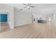 Spacious floor plan with wood floors, kitchen with island, and access to other living areas at 11603 Heron Watch Pl, Riverview, FL 33569