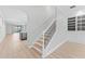 Elegant staircase with wood treads and decorative iron railing, leading to the upper level at 11603 Heron Watch Pl, Riverview, FL 33569