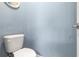 A half bathroom with a white toilet at 12729 Flatwood Creek Dr, Gibsonton, FL 33534