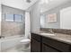 Practical bathroom with a vanity, granite countertop, and a shower-tub combination at 12729 Flatwood Creek Dr, Gibsonton, FL 33534