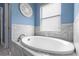 Bright bathroom featuring a luxurious white bathtub with elegant tile surround and natural light at 12729 Flatwood Creek Dr, Gibsonton, FL 33534