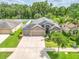 Lovely single-Gathering home with lush landscaping, a two-car garage, and a beautiful front yard; perfect for suburban living at 12729 Flatwood Creek Dr, Gibsonton, FL 33534