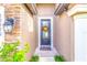 A welcoming front door adorned with a wreath and a 'welcome' mat, complemented by stone accents at 12729 Flatwood Creek Dr, Gibsonton, FL 33534