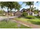 Charming single-Gathering home featuring a stone facade, three-car garage, and lush landscaping at 12729 Flatwood Creek Dr, Gibsonton, FL 33534
