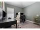 Home office featuring carpet, two desks, two chairs, and two monitors at 12729 Flatwood Creek Dr, Gibsonton, FL 33534