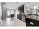 Modern kitchen featuring stainless steel appliances, sleek dark cabinets, and tile flooring at 12729 Flatwood Creek Dr, Gibsonton, FL 33534