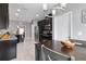 Modern kitchen area with stainless steel appliances and dark cabinetry, with table and chairs at 12729 Flatwood Creek Dr, Gibsonton, FL 33534