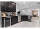 Stylish kitchen features stainless steel appliances and dark cabinetry with a modern design at 12729 Flatwood Creek Dr, Gibsonton, FL 33534