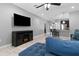Cozy living room featuring tile flooring, a ceiling fan, and a view into the kitchen at 12729 Flatwood Creek Dr, Gibsonton, FL 33534