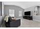 Comfortable living room featuring two windows, tile floors, and gray paint at 12729 Flatwood Creek Dr, Gibsonton, FL 33534