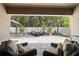 A serene outdoor patio area with comfortable seating, offering a peaceful view of the backyard and landscaping at 12729 Flatwood Creek Dr, Gibsonton, FL 33534