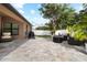 A charming patio area with ample space for seating, a grill, and a fire pit, ideal for gatherings and relaxation at 12729 Flatwood Creek Dr, Gibsonton, FL 33534
