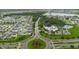 A wide aerial view shows the community pool and clubhouse and a beautiful roundabout in the foreground at 13016 Boggy Creek Dr, Riverview, FL 33579