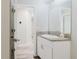 Bathroom featuring a vanity with granite countertop and white cabinetry at 13016 Boggy Creek Dr, Riverview, FL 33579