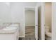 Bathroom with double sink, granite countertops, and toilet, next to bedroom at 13016 Boggy Creek Dr, Riverview, FL 33579