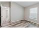Bedroom with neutral paint, modern wood-look flooring, and a view into the hall at 13016 Boggy Creek Dr, Riverview, FL 33579