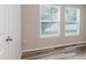 Bedroom featuring wood-look flooring, neutral paint, and two sunny windows at 13016 Boggy Creek Dr, Riverview, FL 33579