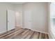 Bedroom with wood-look floors, neutral walls and open door in the background at 13016 Boggy Creek Dr, Riverview, FL 33579
