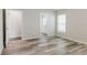 Bright bedroom featuring modern vinyl floors and neutral paint, leading to an ensuite bathroom at 13016 Boggy Creek Dr, Riverview, FL 33579