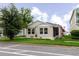 Inviting single-story home with a tidy front yard, lush green grass, and meticulous landscaping at 13016 Boggy Creek Dr, Riverview, FL 33579