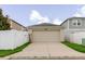 Attached garage with a neutral facade, offering secure parking and storage space with a driveway at 13016 Boggy Creek Dr, Riverview, FL 33579