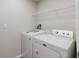 Laundry room featuring a modern washer and dryer, and a wire shelf at 13016 Boggy Creek Dr, Riverview, FL 33579