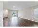 Open-concept living room featuring wood-look flooring and a sliding glass door with backyard access at 13016 Boggy Creek Dr, Riverview, FL 33579
