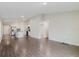 Spacious open-concept living area featuring wood flooring, a modern kitchen, and bright, neutral walls at 13016 Boggy Creek Dr, Riverview, FL 33579