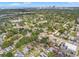 Aerial shot featuring a residential neighborhood with lush trees and distant city skyline at 1419 30Th N Ave, St Petersburg, FL 33704