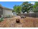 Fenced backyard featuring a fire pit, stone picnic table, and an outdoor shed at 1419 30Th N Ave, St Petersburg, FL 33704