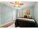 Comfortable bedroom with wood floors, a ceiling fan, neutral walls, and large windows at 1419 30Th N Ave, St Petersburg, FL 33704