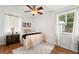 Cozy bedroom with hardwood floors, ceiling fan, area rug, and lots of natural light at 1419 30Th N Ave, St Petersburg, FL 33704