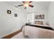 Comfortable bedroom with wood floors, ceiling fan, area rug, and an art decoration at 1419 30Th N Ave, St Petersburg, FL 33704