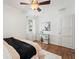 Bright bedroom featuring wood floors, neutral walls, ceiling fan, and art decoration at 1419 30Th N Ave, St Petersburg, FL 33704